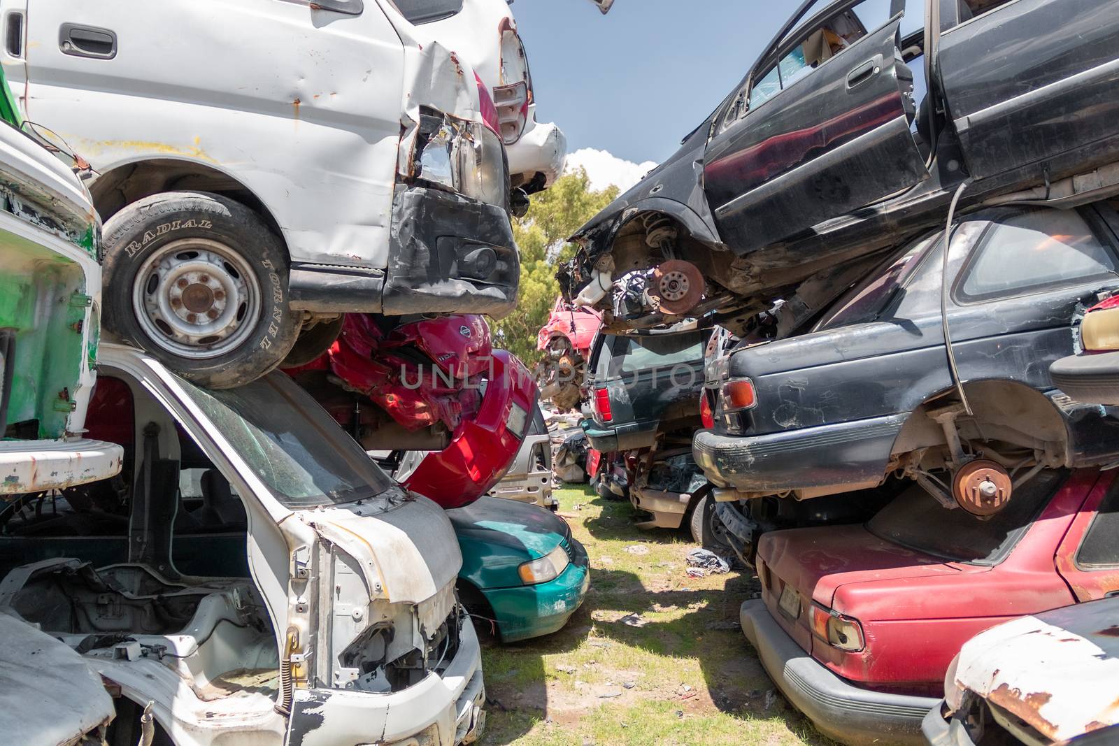 Mexico City / Mexico. June 19 2020: Old Cars Piled up in a Metal Recycling Yard Waiting to be Dismantled and Crushed. by leo_de_la_garza