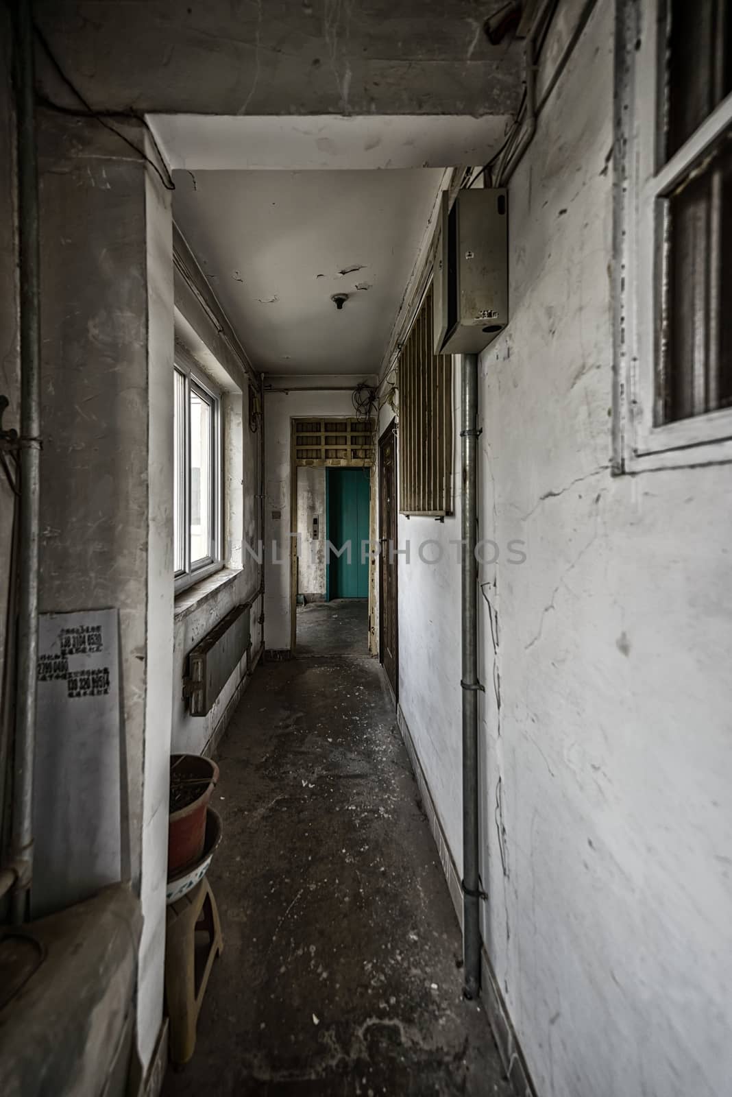 Abandoned grungy corridor in building vertical shot