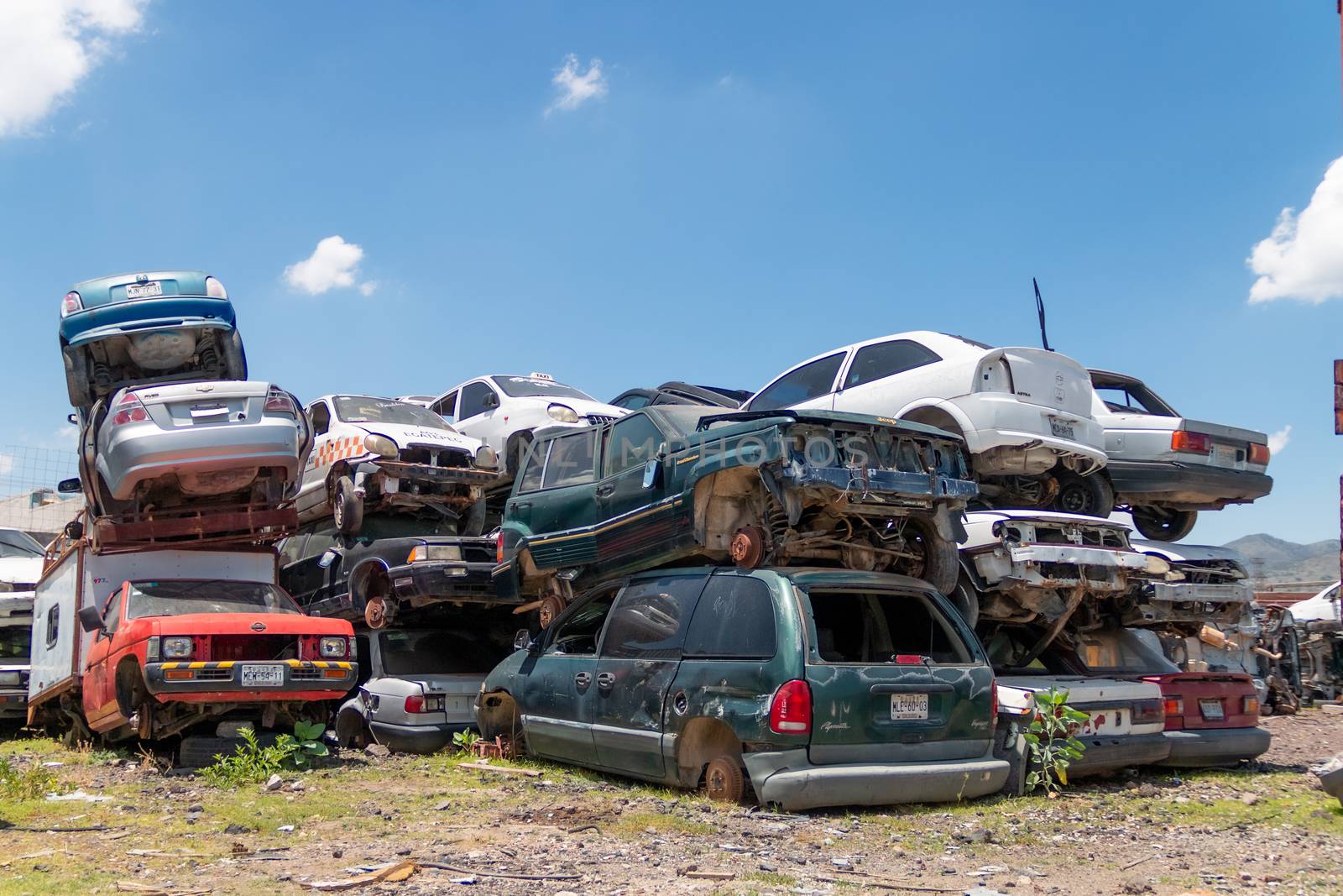 Mexico City / Mexico. June 19 2020: Old Cars Piled up in a Metal Recycling Yard Waiting to be Dismantled and Crushed. by leo_de_la_garza