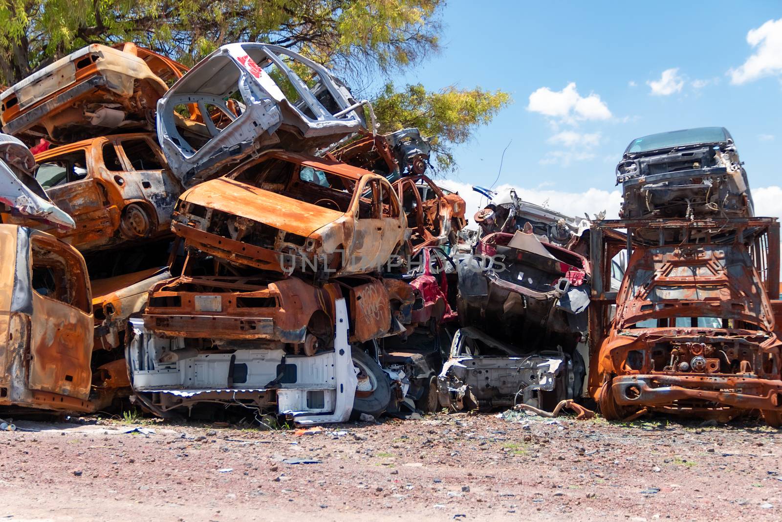 Mexico City / Mexico. June 19 2020: Old Cars Piled up in a Metal Recycling Yard Waiting to be Dismantled and Crushed. by leo_de_la_garza