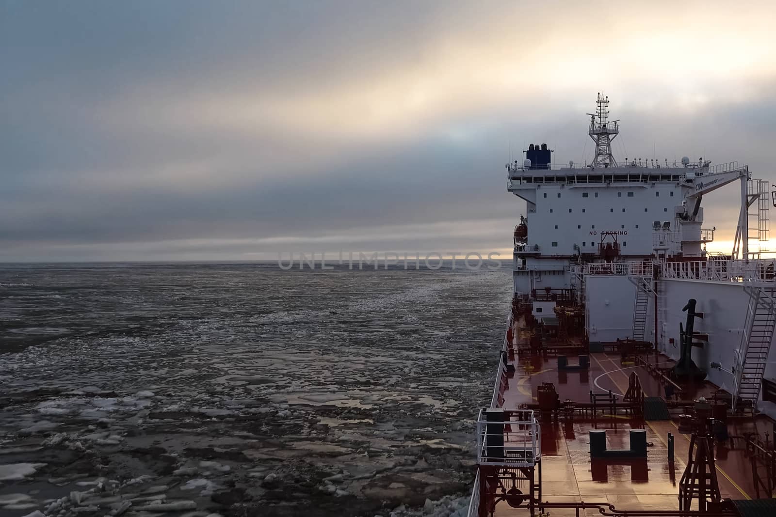 The feed of a ship sailing in the Arctic. Landscape of the Arctic from the deck of the tanker.