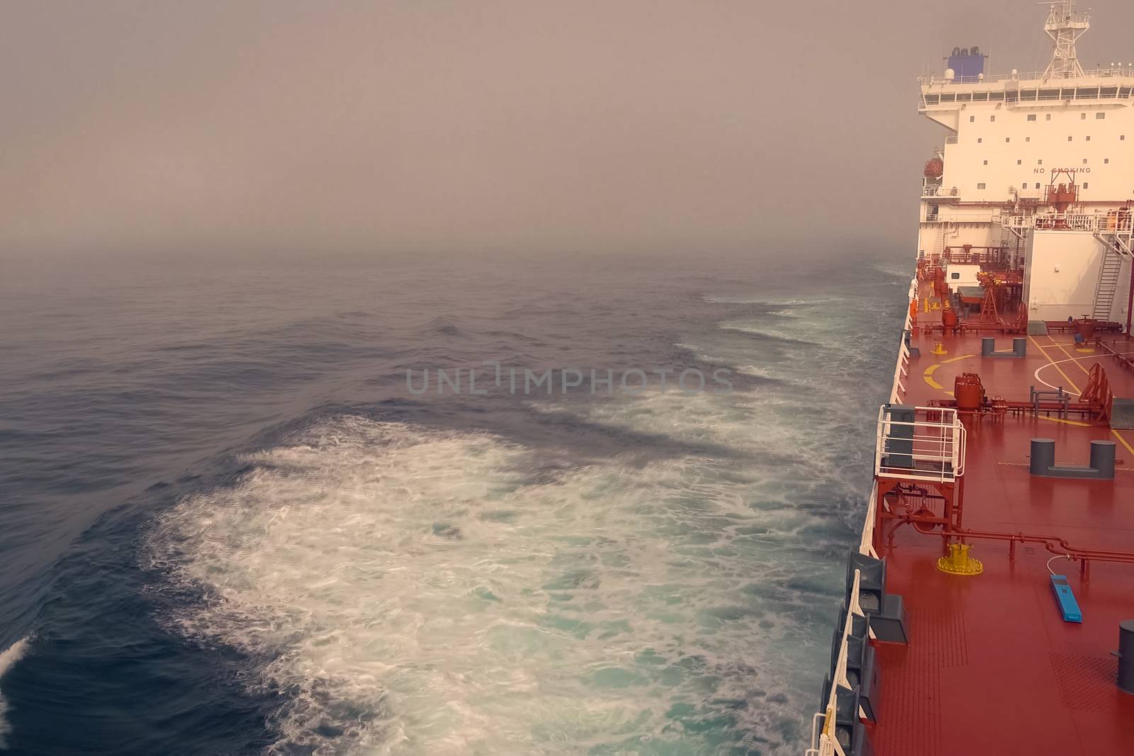 The feed of a ship sailing in the Arctic. Landscape of the Arctic from the deck of the tanker.