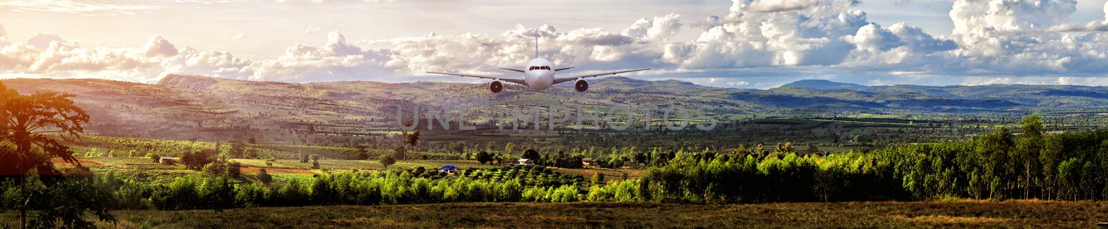 Airplane frying over the green rice flied Mountain background