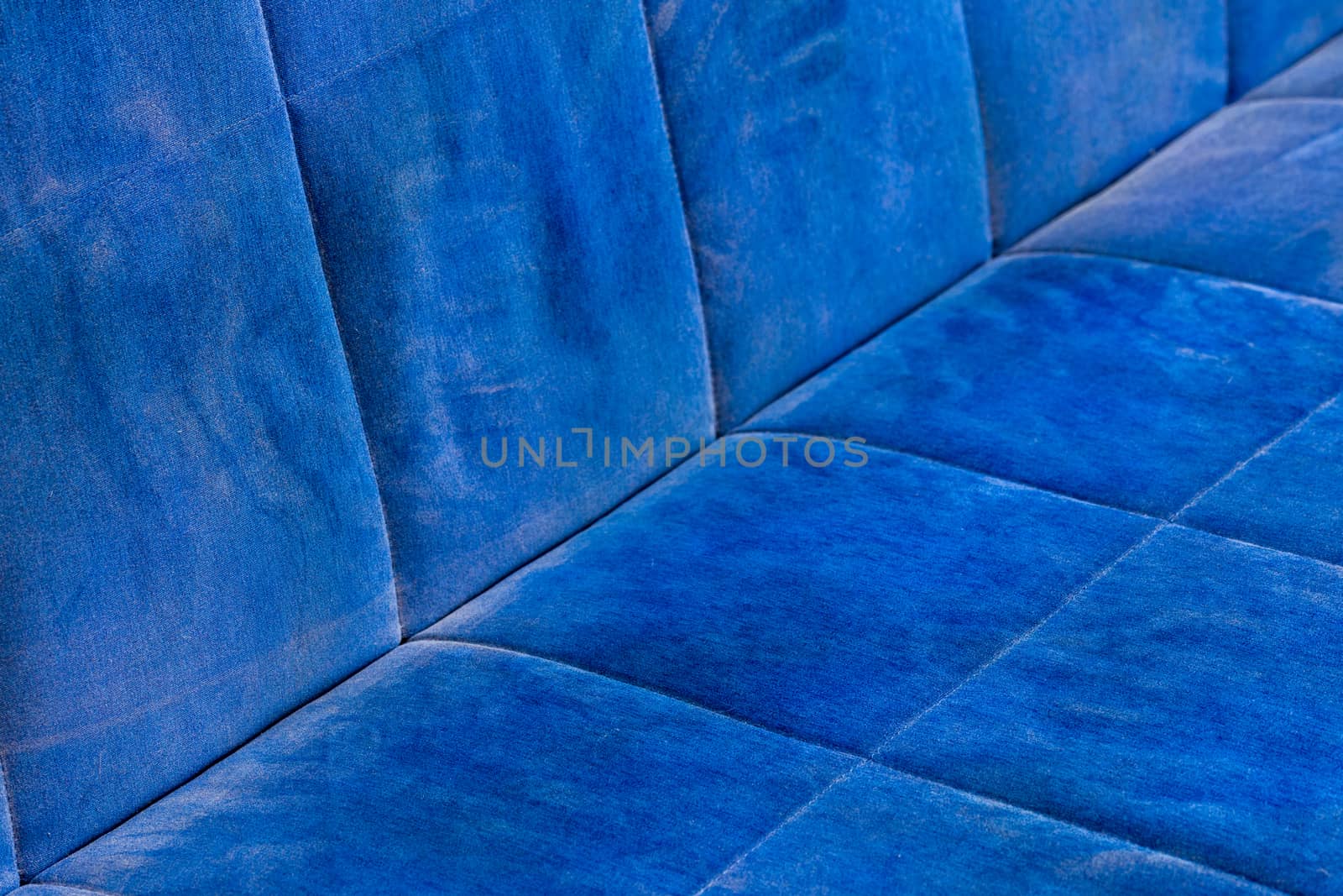 dusty blue sofa surface with palm prints closeup with selective focus.