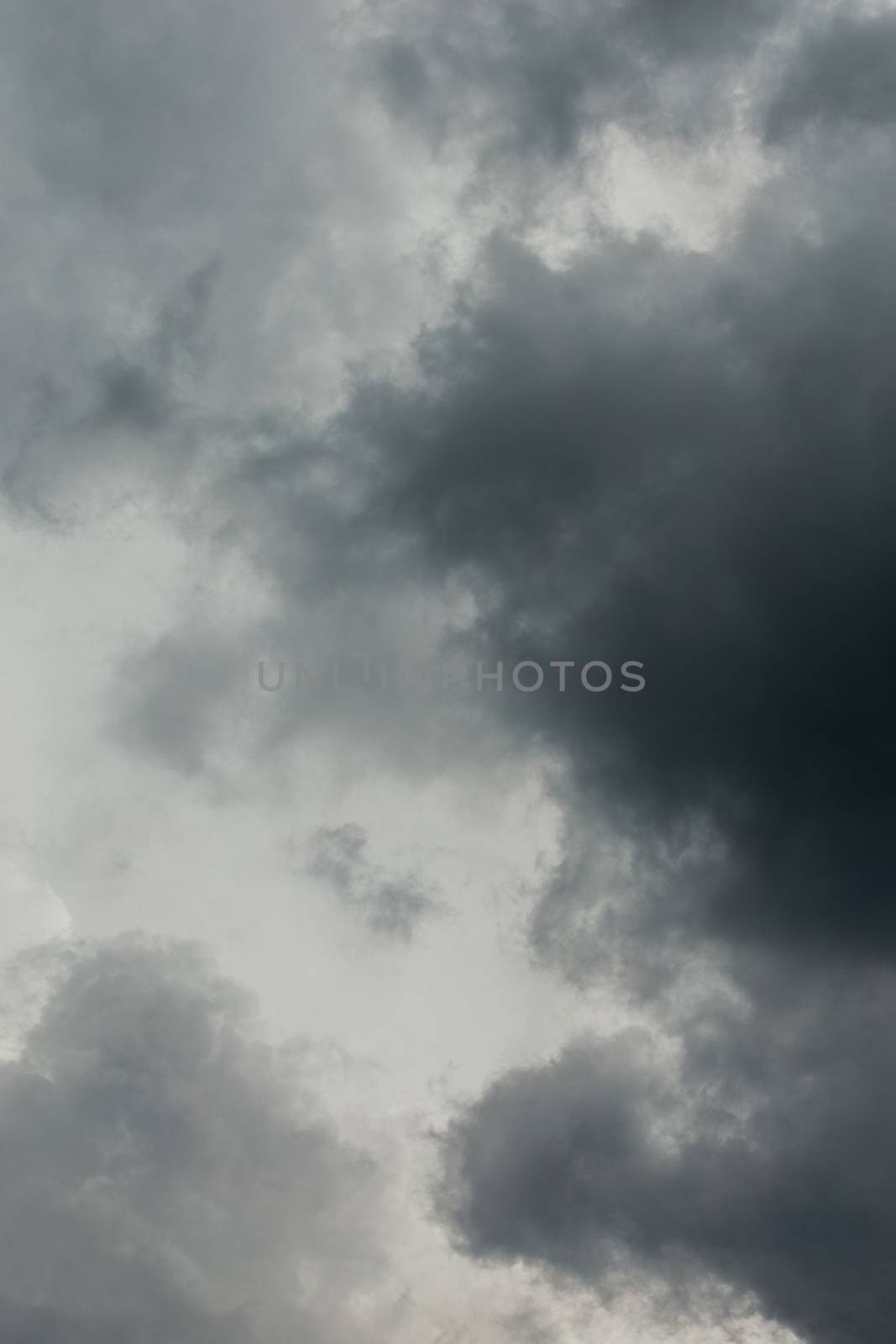 gray incoming storm clouds dark closeup backdrop, captured on 100 mm telephoto lens