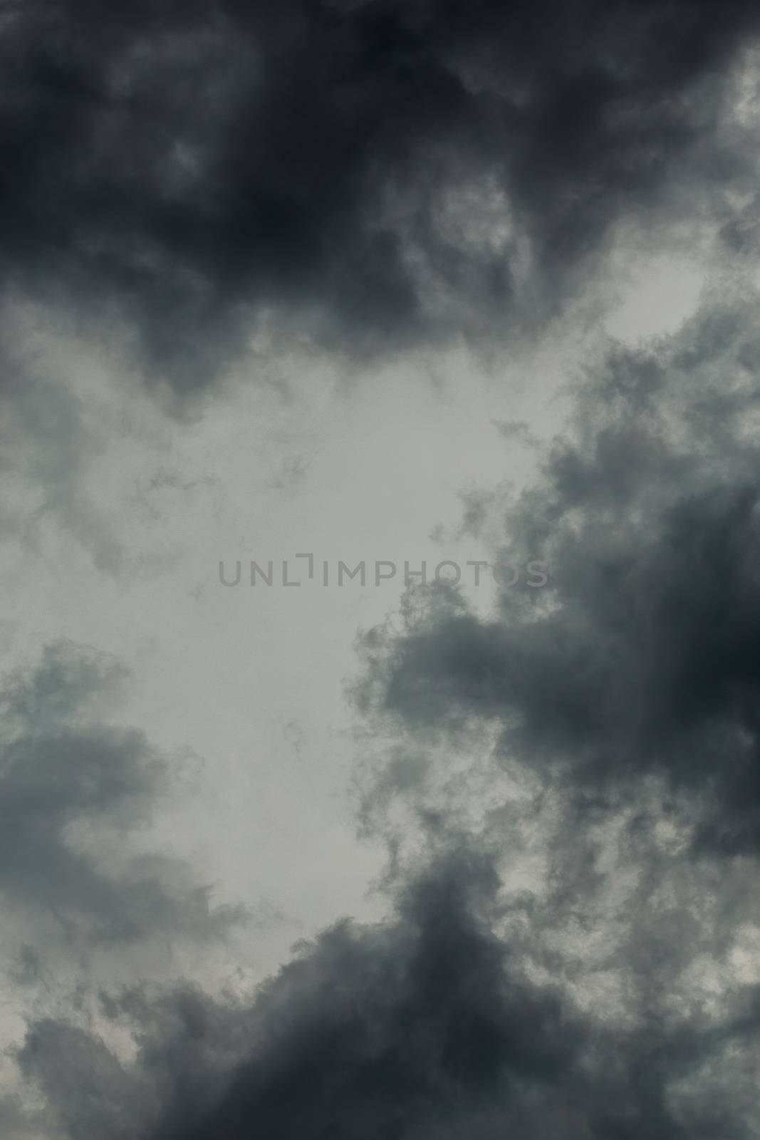 gray incoming storm clouds dark closeup vertical backdrop, captured on 100 mm telephoto lens