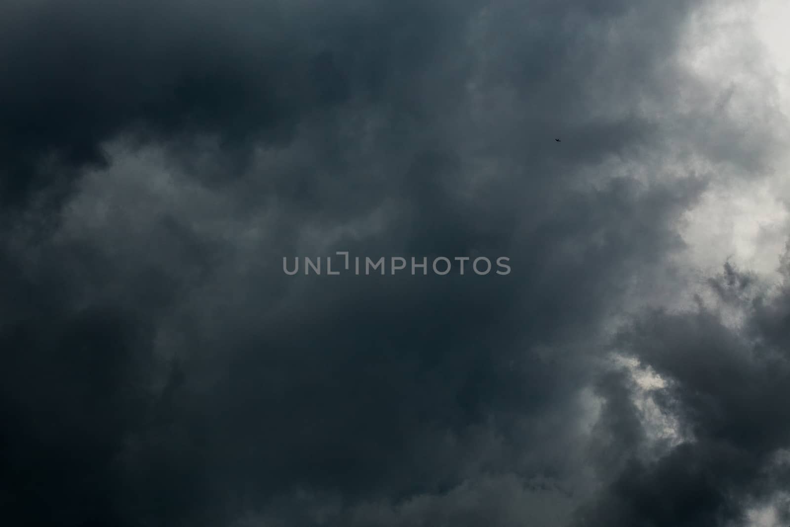 gray incoming storm clouds dark closeup backdrop, captured on 100 mm telephoto lens