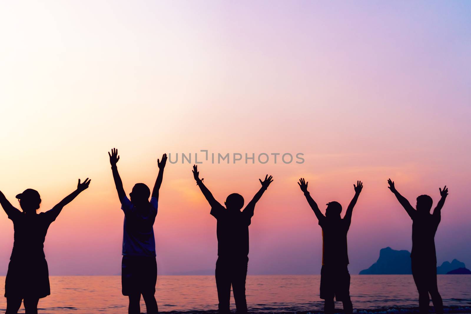 Silhouette woman rise hands up to sky freedom concept with sunset sky and summer beach season background.