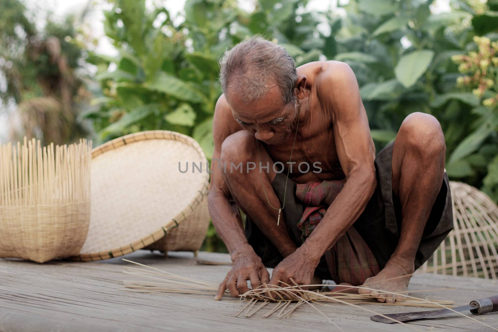 Oldman in countryside are weaving. by start08