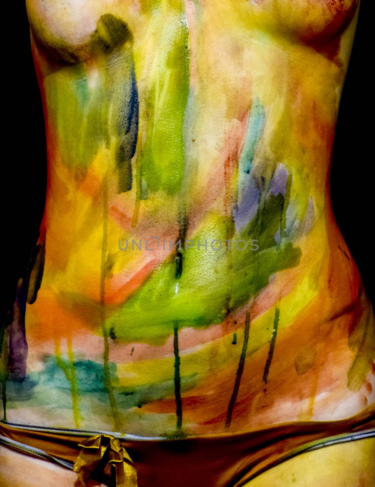 Body art. Drawing on the body. Beautiful girl with painted body watercolors. A white young girl painted the body with paint by eleonimages