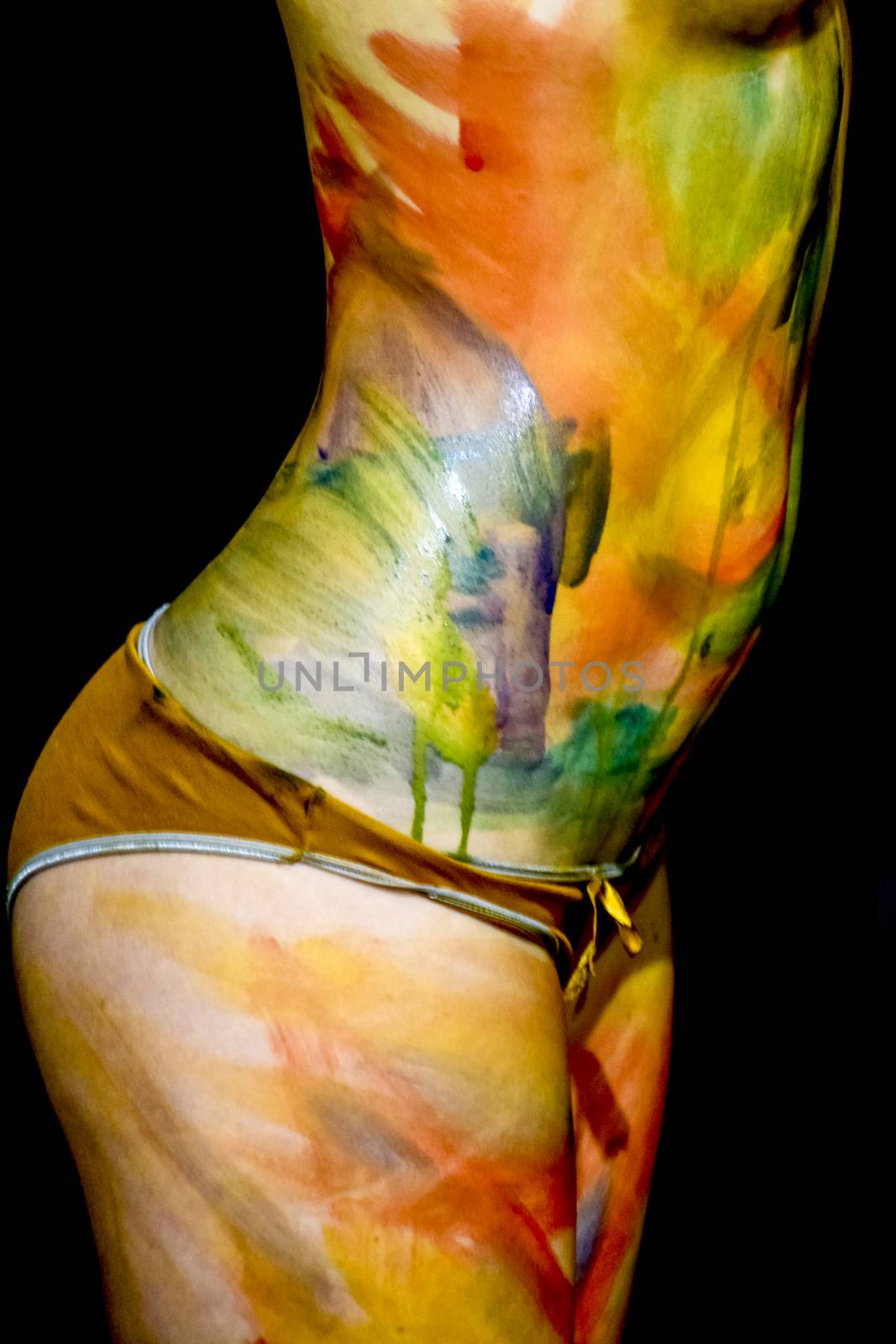 Body art. Drawing on the body. Beautiful girl with painted body watercolors. A white young girl painted the body with paint by eleonimages