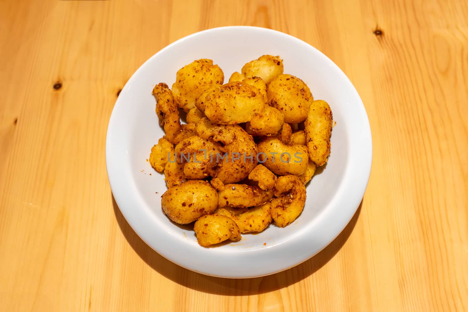 Fried potatoes with spice in a white plate - Chinese food