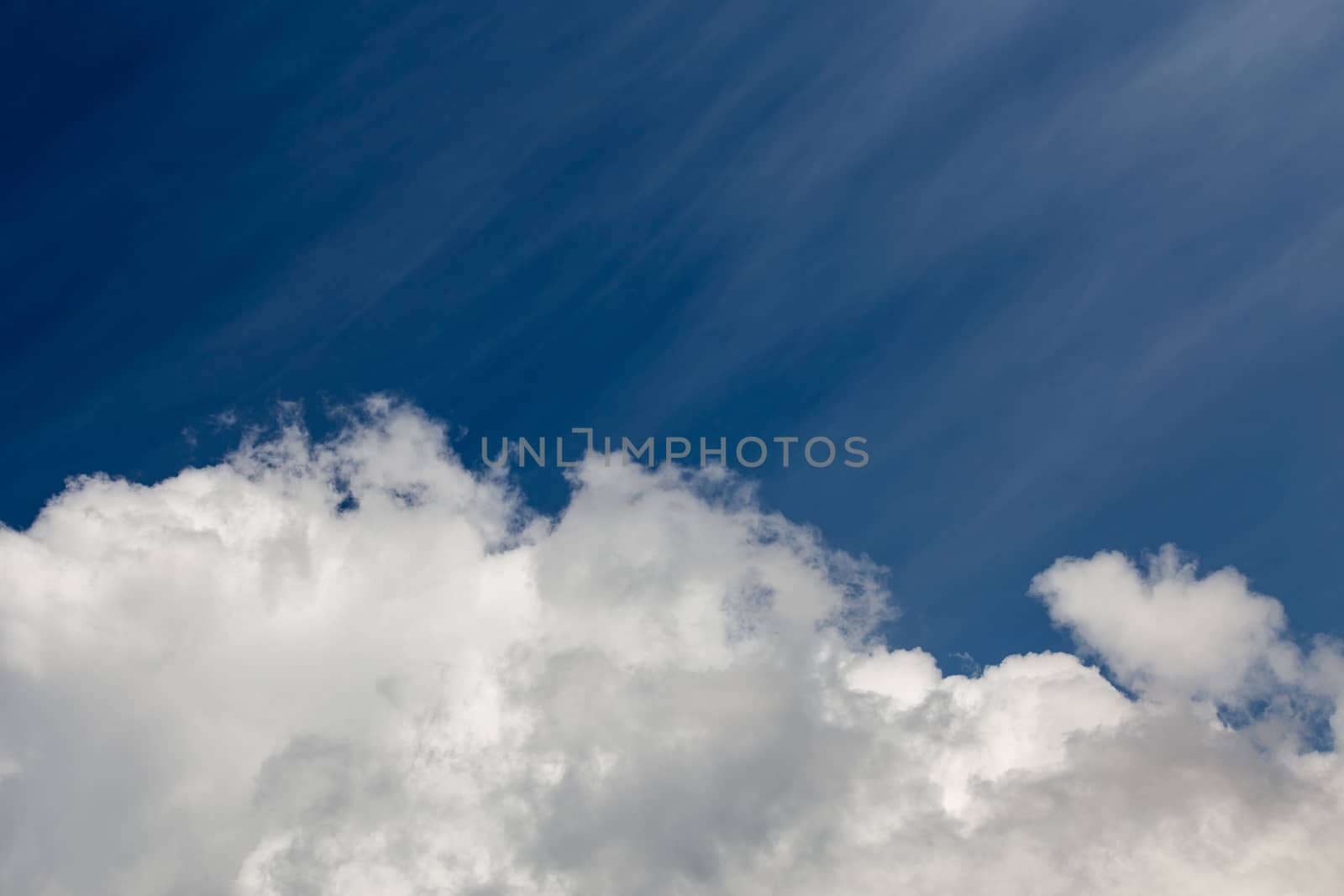 White cloud and blue sky at daylight. Close shot wit telephoto lens and polarizing filter with minimalistic composition.