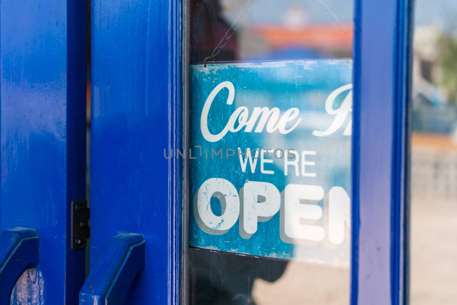 A business sign that says open on cafe or restaurant hang on door at entrance. Vintage color tone style.