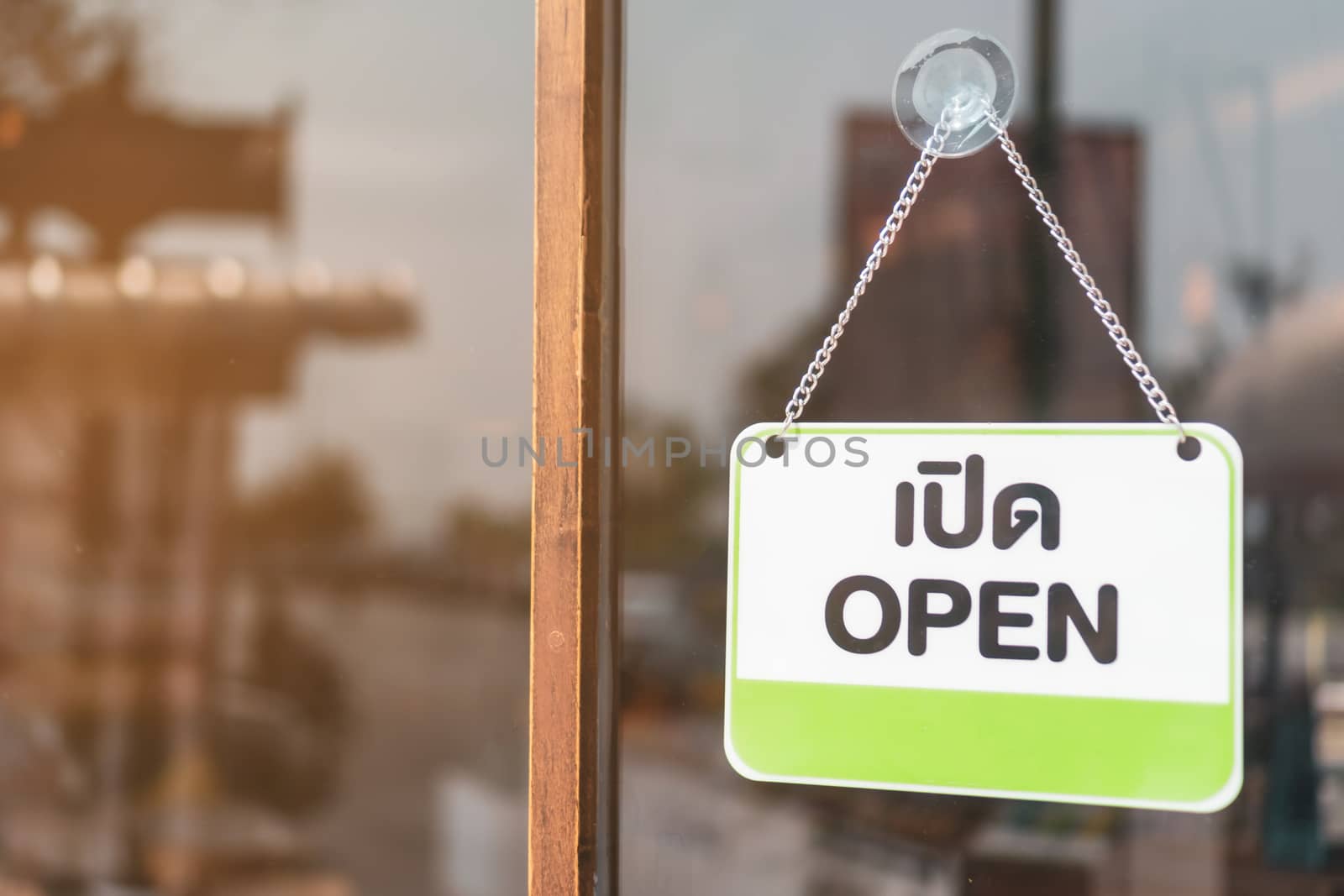 A business sign that says open on cafe or restaurant hang on door at entrance. Vintage color tone style.