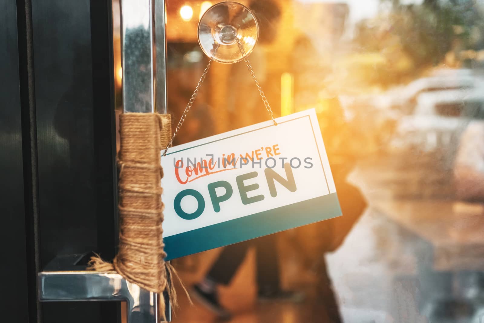 A business sign that says open on cafe or restaurant hang on door at entrance. Vintage color tone style.