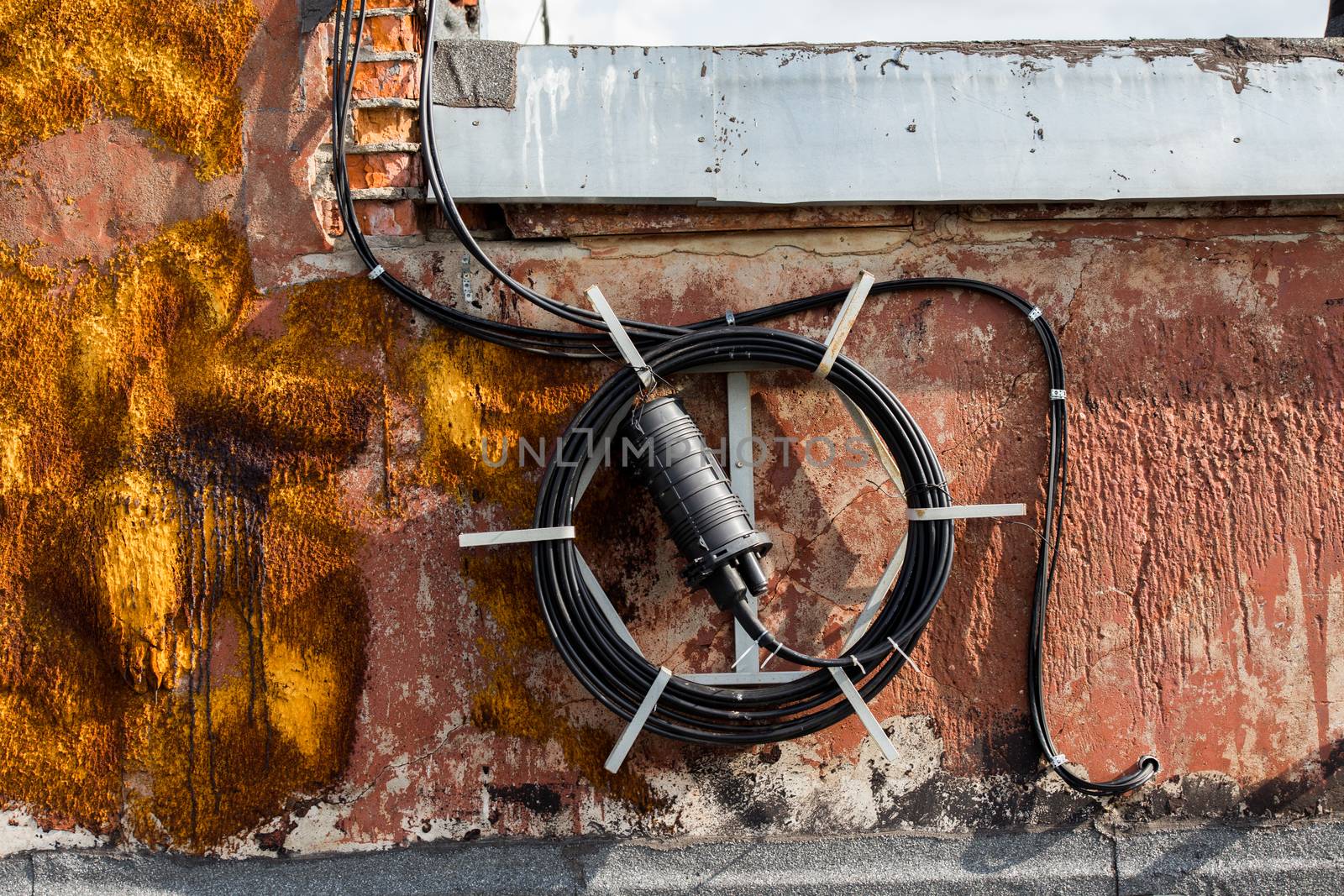 spool of long black wire on the roof of a house somewhere in russia.