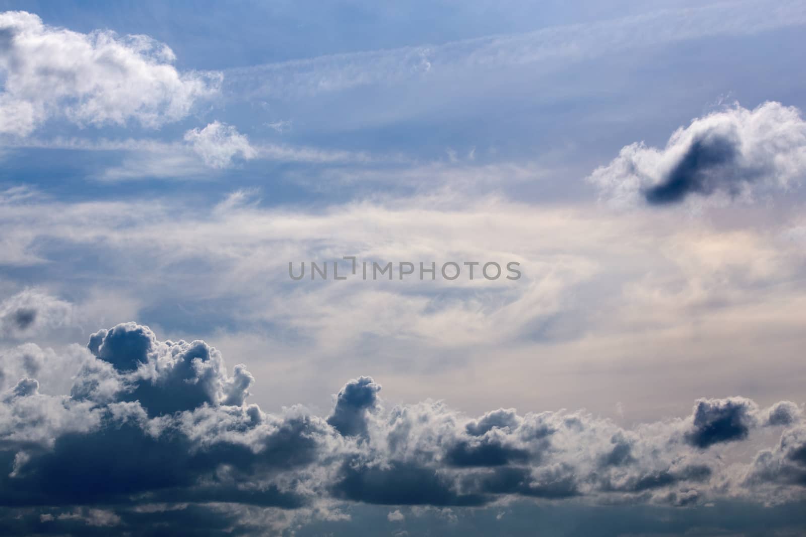 distant mixed cumulus and feather clouds near horizon closeup telephoto shot with polarizing effect