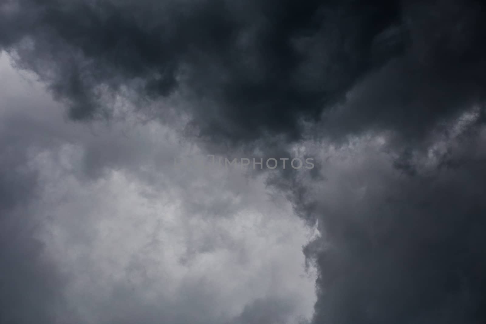 gray incoming storm clouds dark closeup backdrop, captured on 100 mm telephoto lens