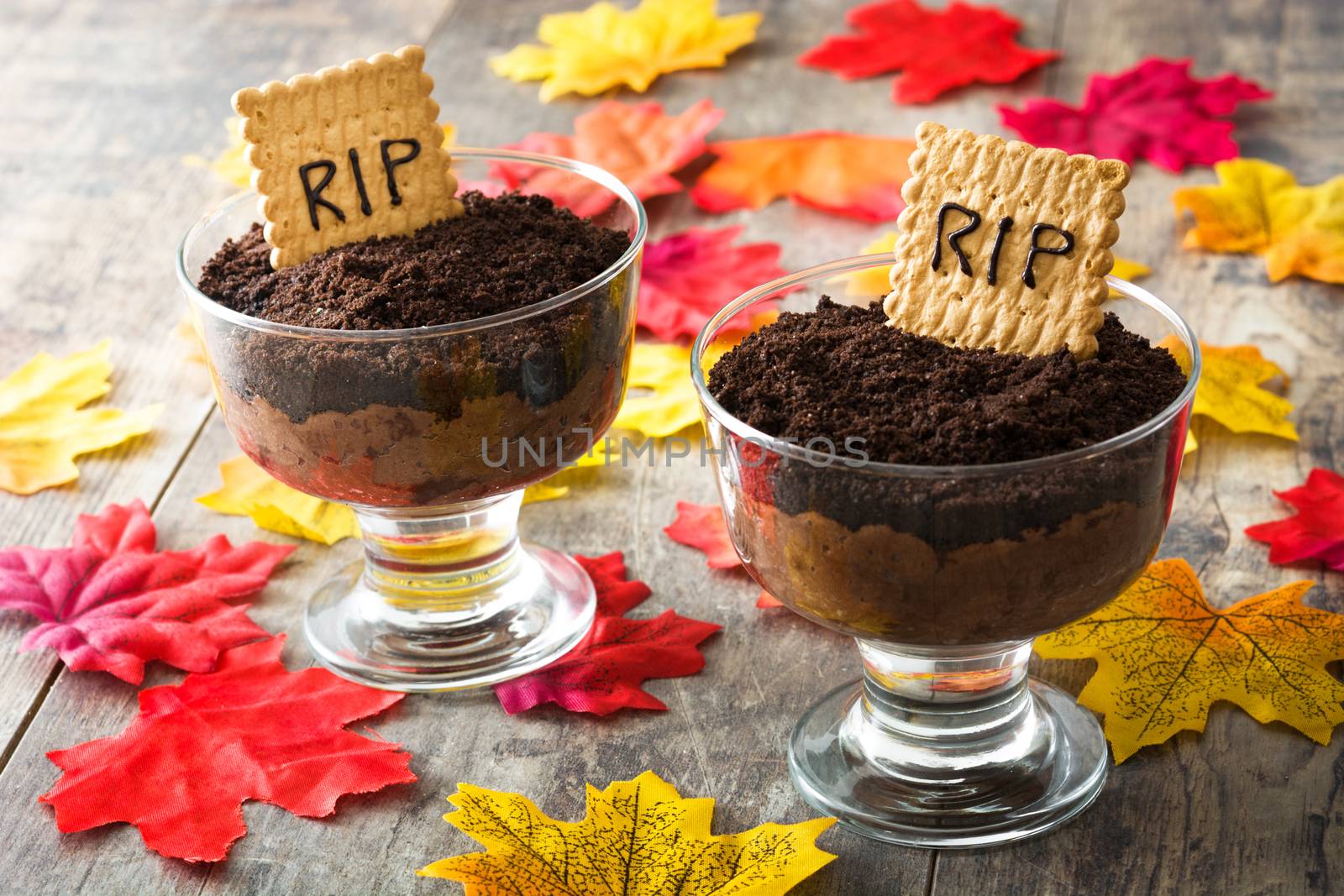 Funny Halloween chocolate mousse with tomb cookie on wooden table by chandlervid85