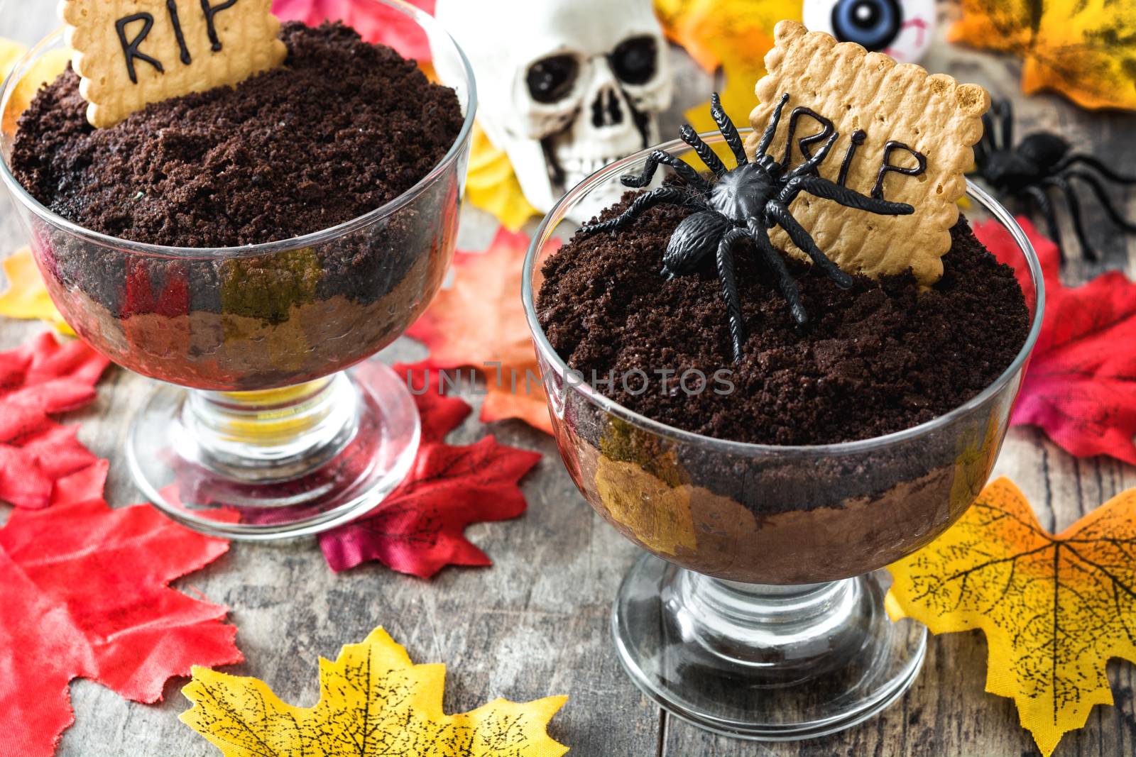 Funny Halloween chocolate mousse with tomb cookie on wooden table by chandlervid85