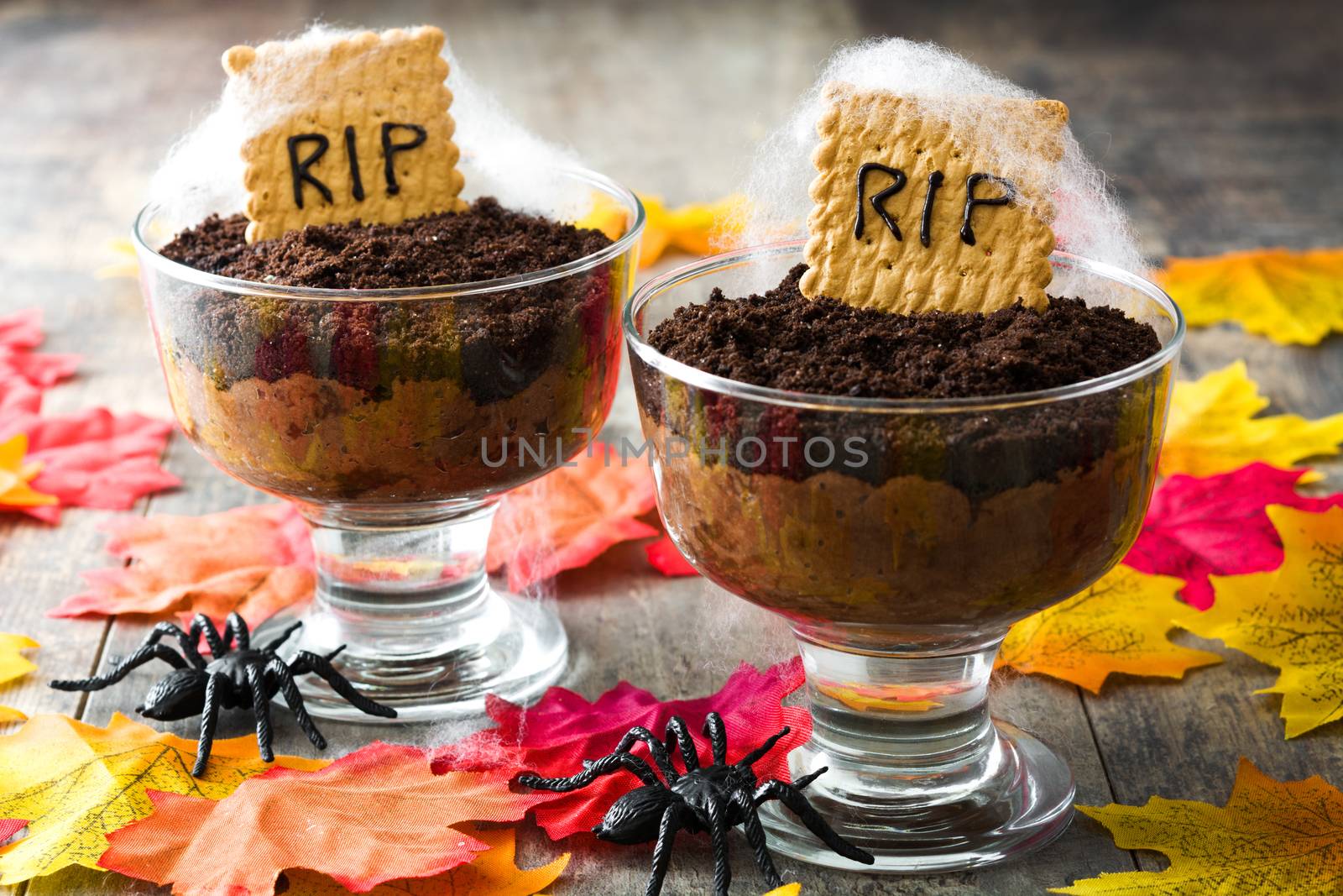 Funny Halloween chocolate mousse with tomb cookie on wooden table by chandlervid85