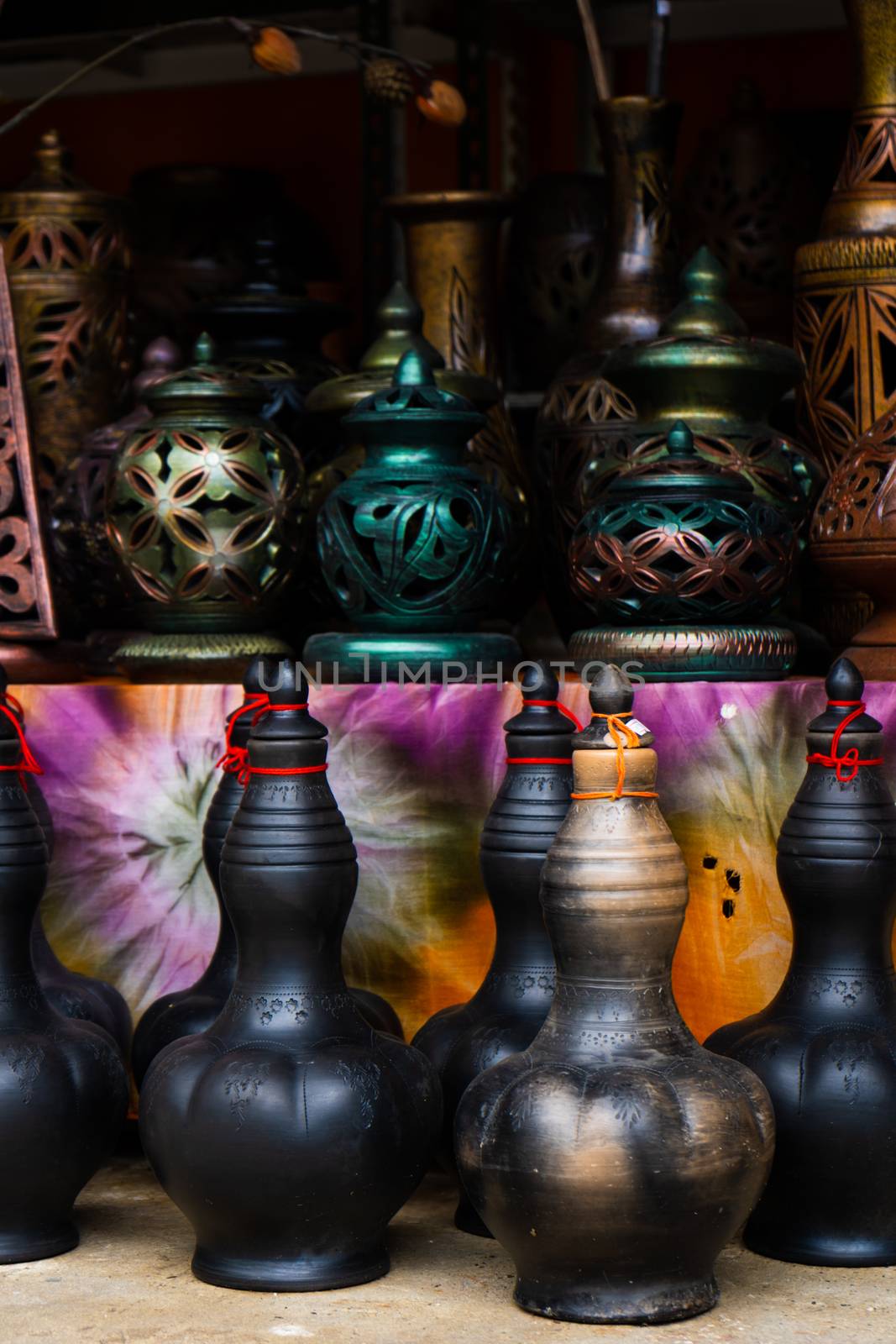 Showcase with clay pots from handmade jugs. Asian traditional jugs.