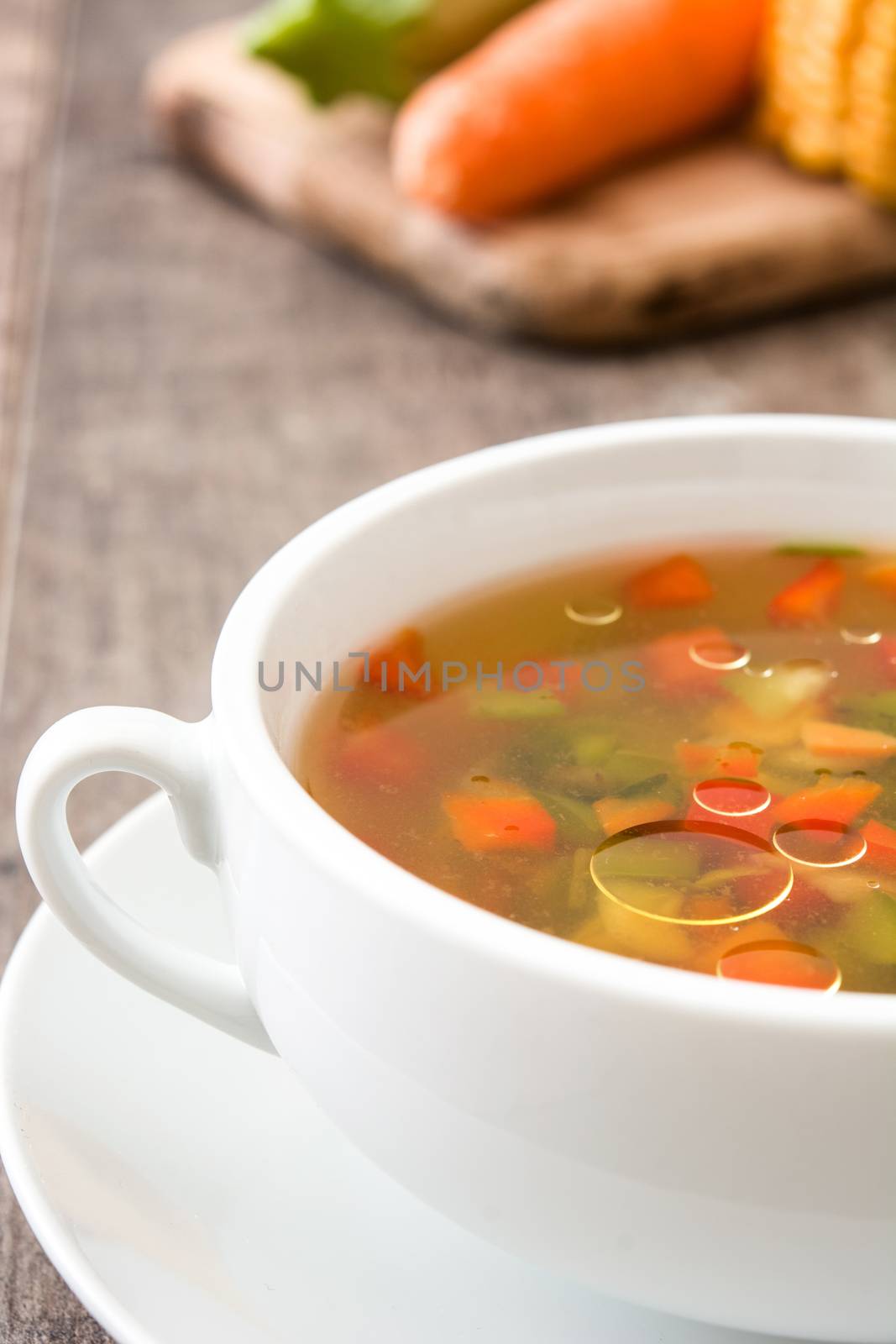Vegetable soup in bowl on wooden table
