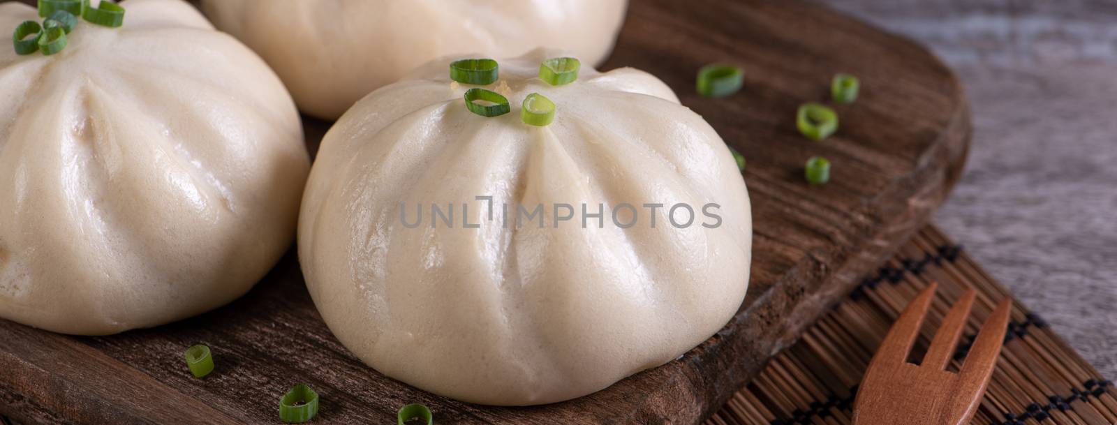 Delicious baozi, Chinese steamed meat bun is ready to eat on ser by ROMIXIMAGE