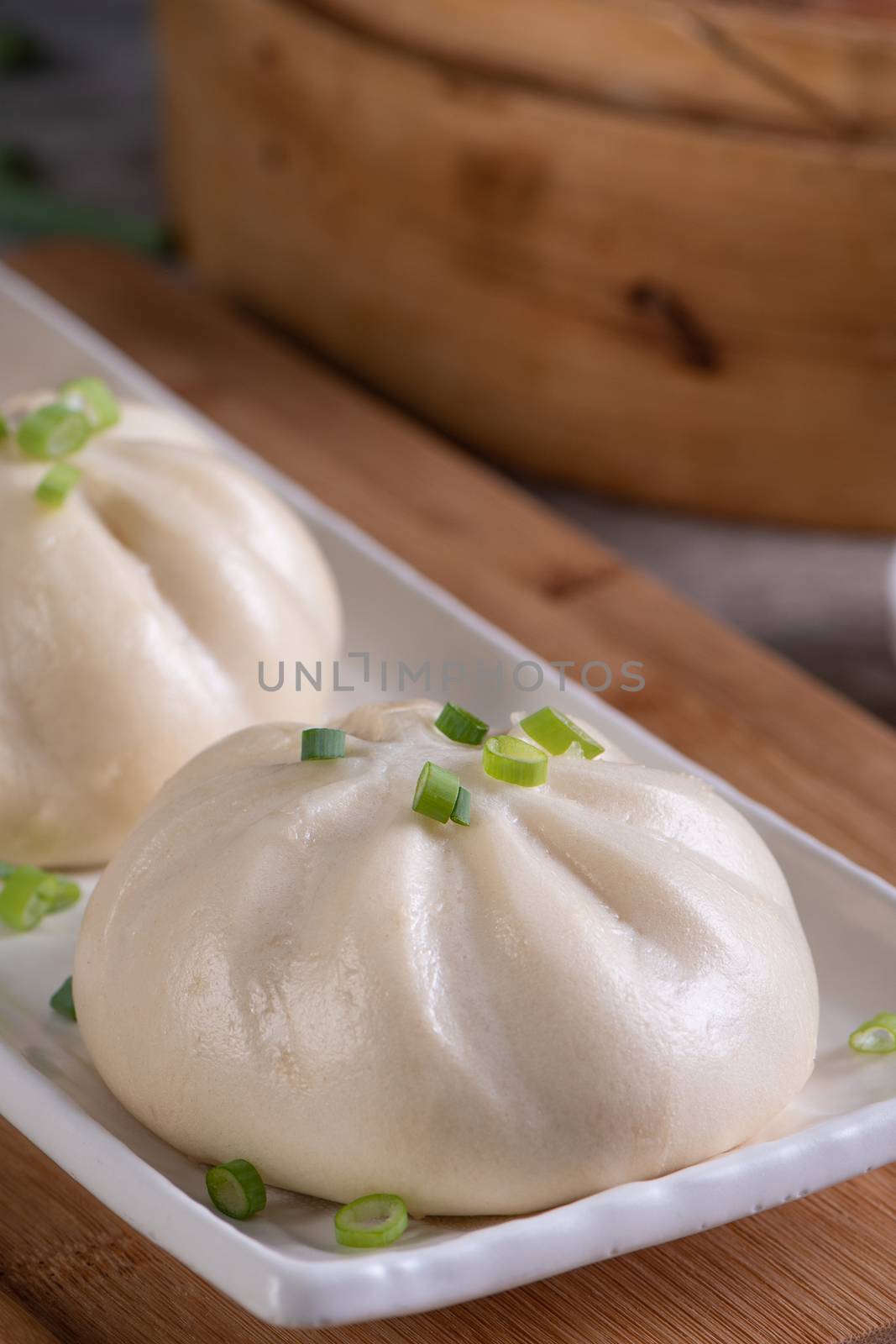 Delicious baozi, Chinese steamed meat bun is ready to eat on ser by ROMIXIMAGE