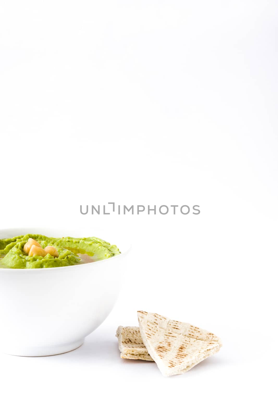 Avocado hummus in bowl isolated on white background by chandlervid85