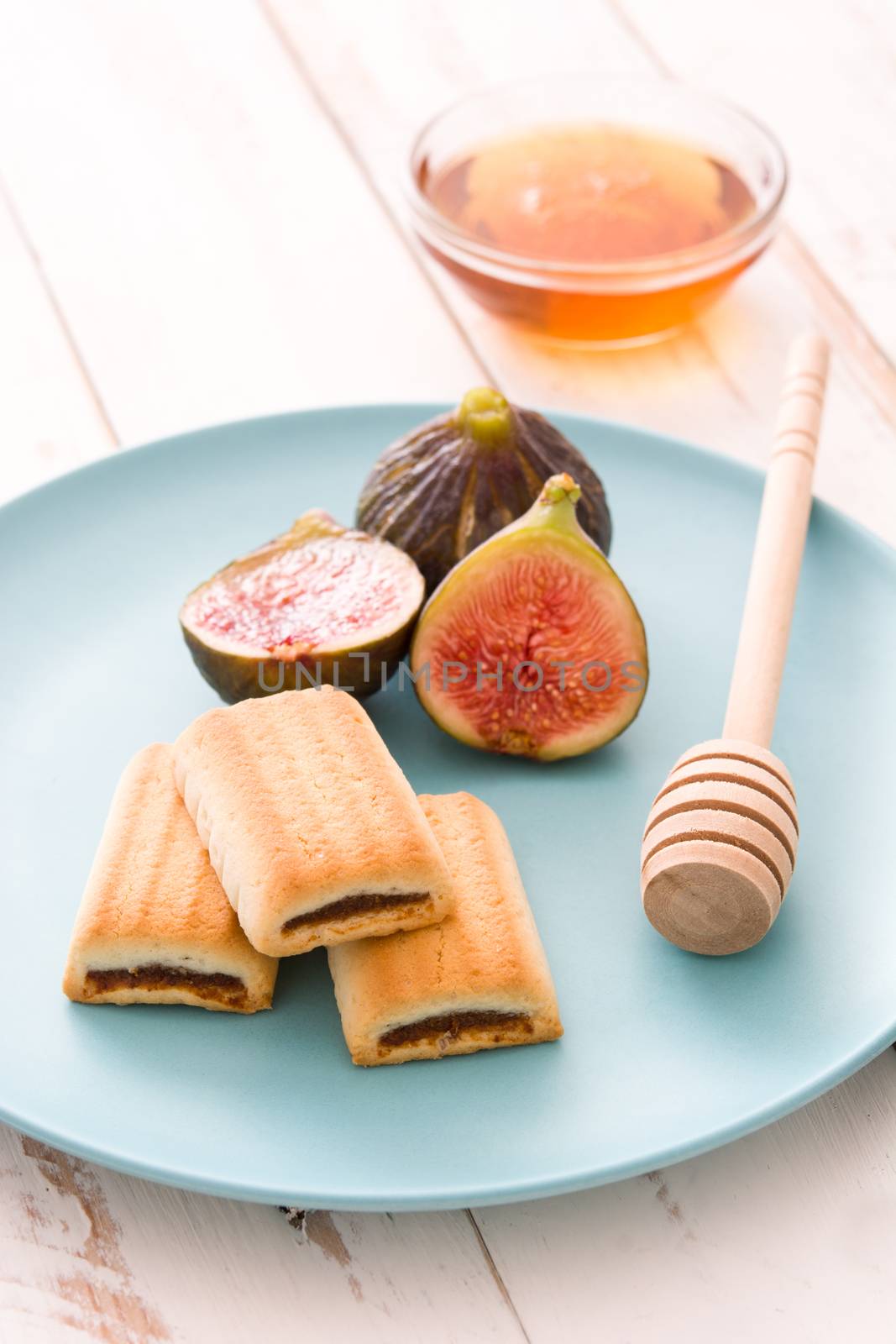Fig cookies with honey on white wooden table