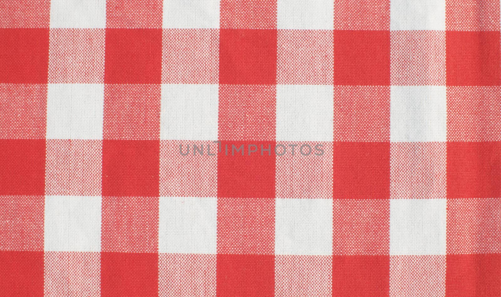 Extreme close up - plaid cotton tablecloth. Texture, textile background. Macro shooting, camera slowly moving along the cloth on slider.