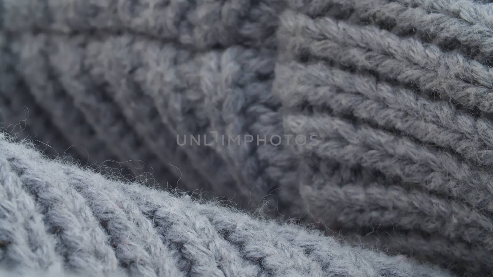 Extreme close up thick gray wool knitted sweater. Texture, textile background. Macro shooting