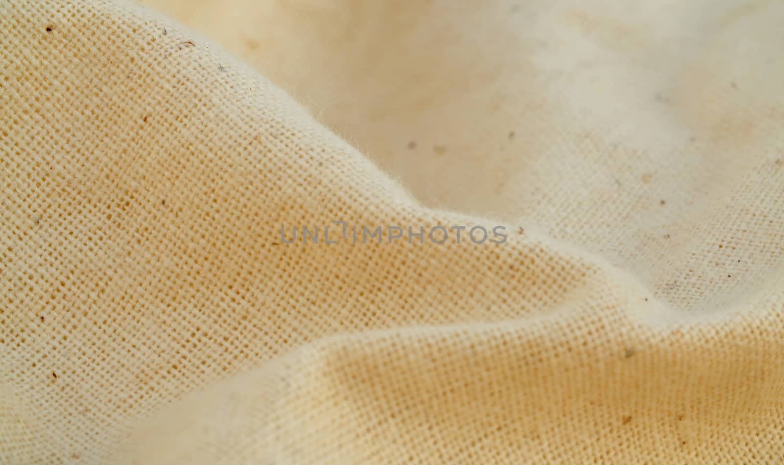 Extreme close up - white natural fabric of rare weaving. Texture, textile background. Macro shooting