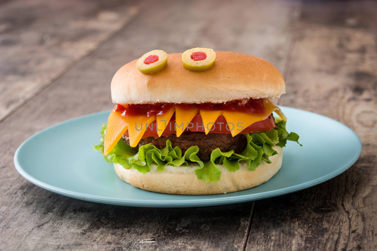 Halloween burger monsters on wooden table by chandlervid85