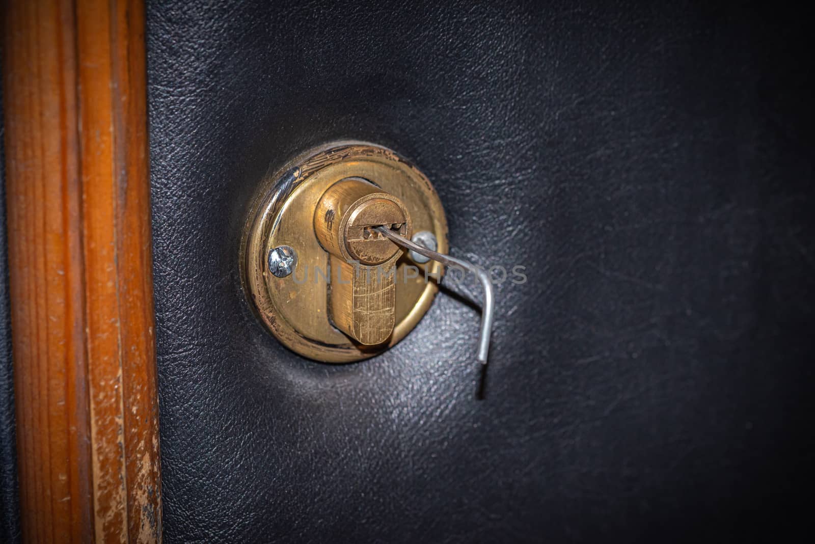 Lock picking, a tension wrench is inserted in the lock of a security door