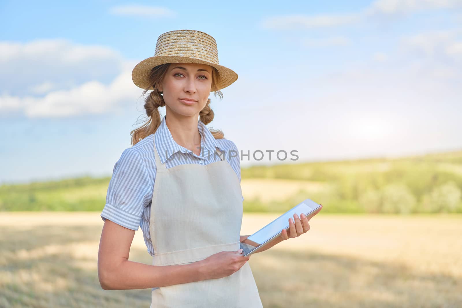 Woman farmer straw hat smart farming standing farmland smiling using digital tablet Female agronomist specialist research monitoring analysis data agribusiness by andreonegin