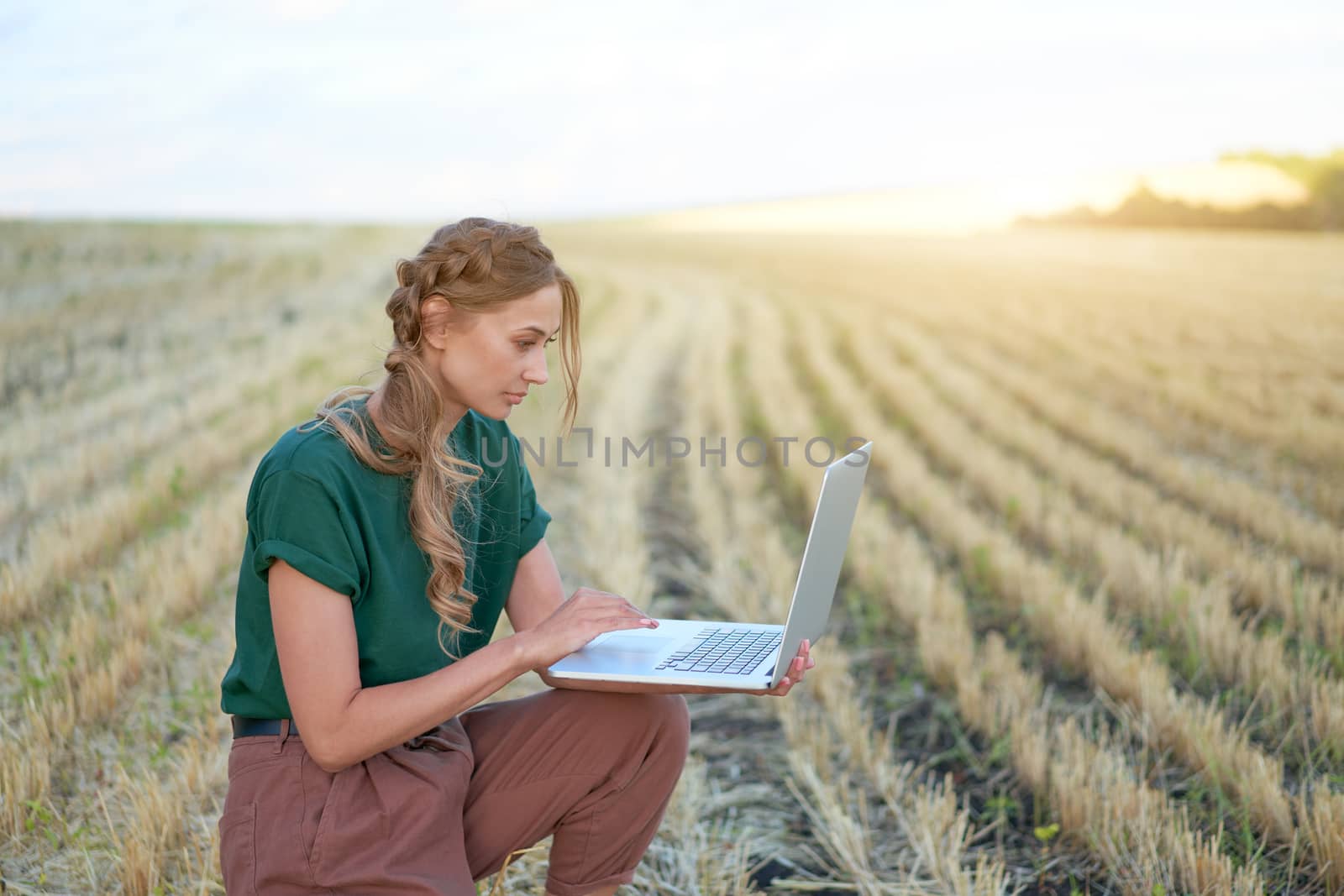 Woman farmer smart farming standing farmland smiling using laptop Female agronomist specialist research monitoring analysis data agribusiness by andreonegin