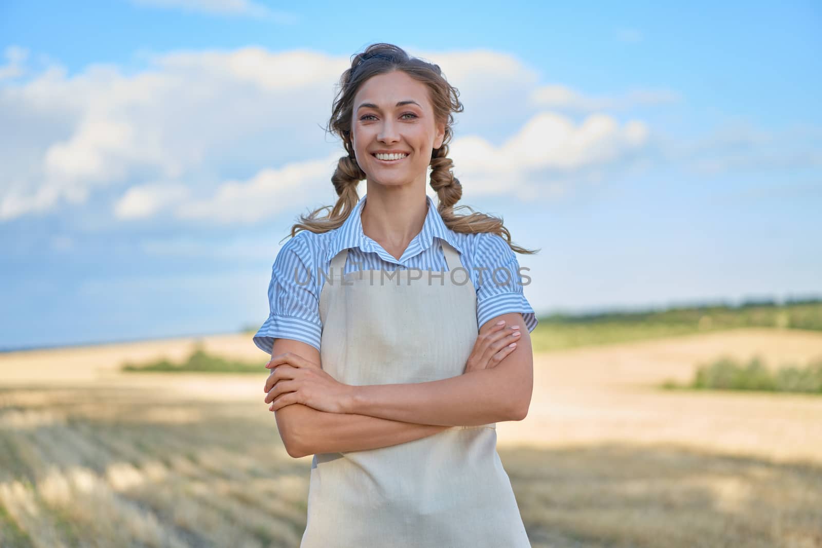 Woman farmer apron standing farmland smiling Female agronomist specialist farming agribusiness Happy positive caucasian worker agricultural field by andreonegin