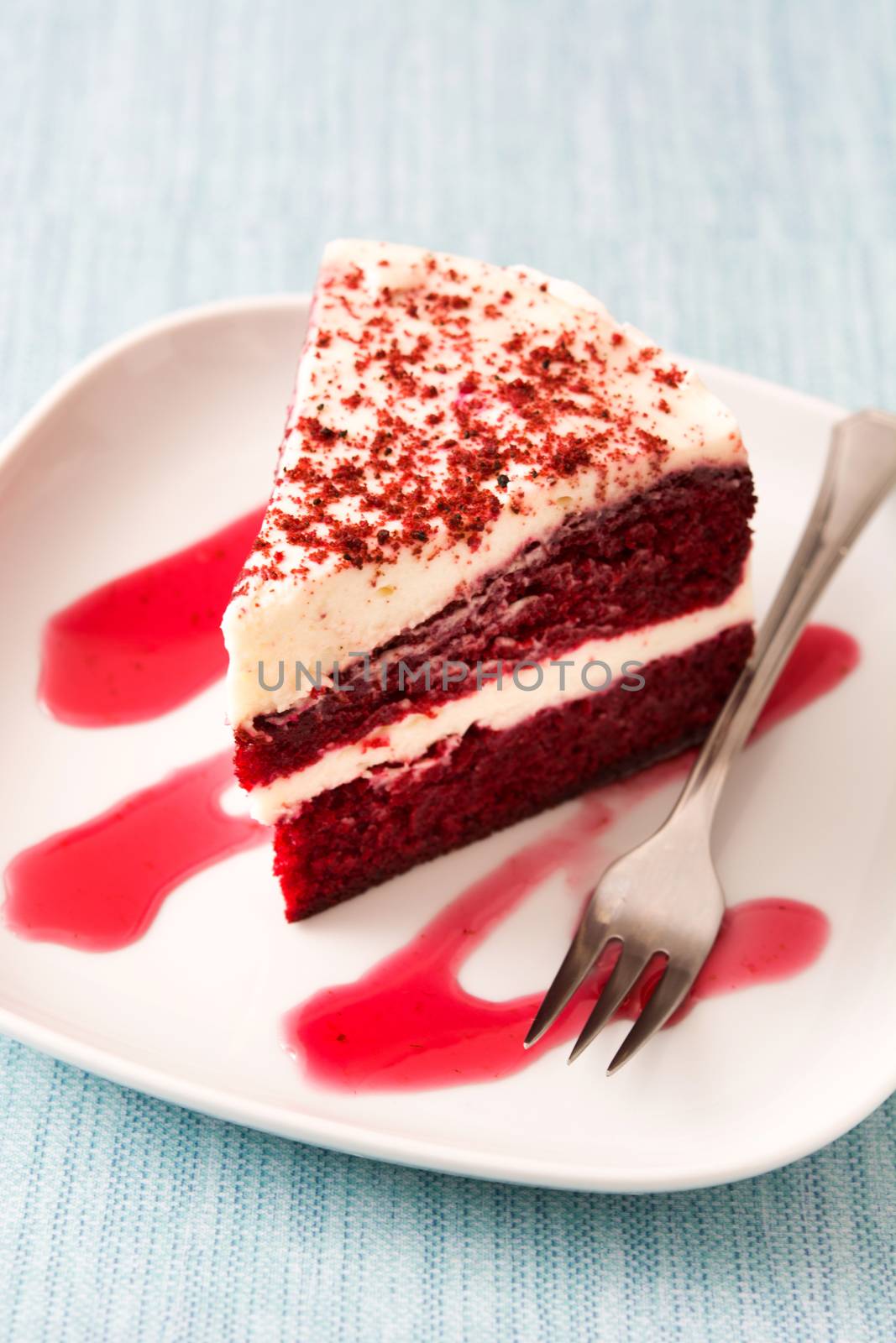 Red Velvet cake slice on blue background by chandlervid85