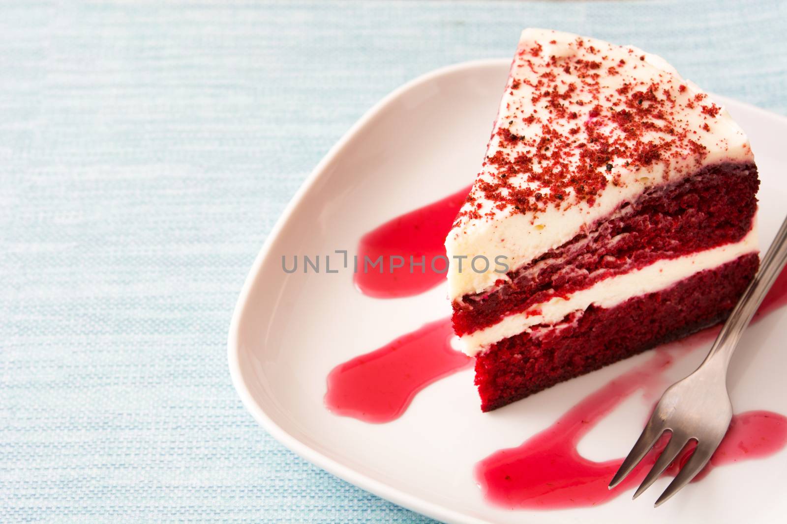 Red Velvet cake slice on blue background