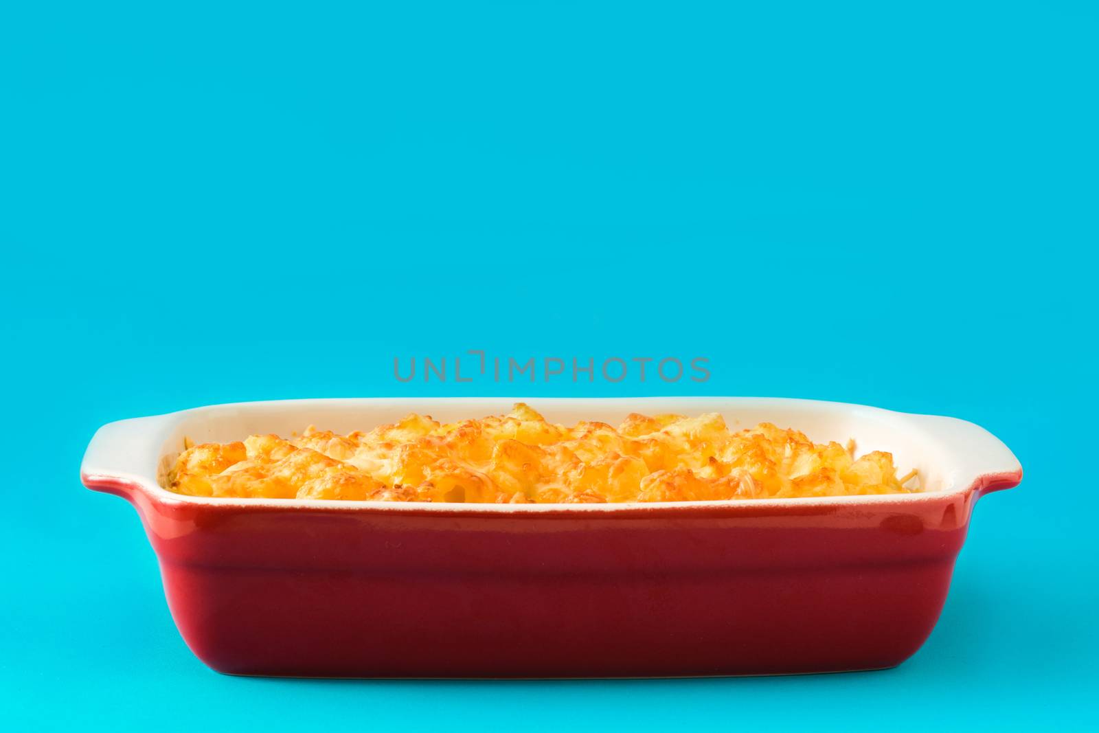 Typical American macaroni and cheese on blue background