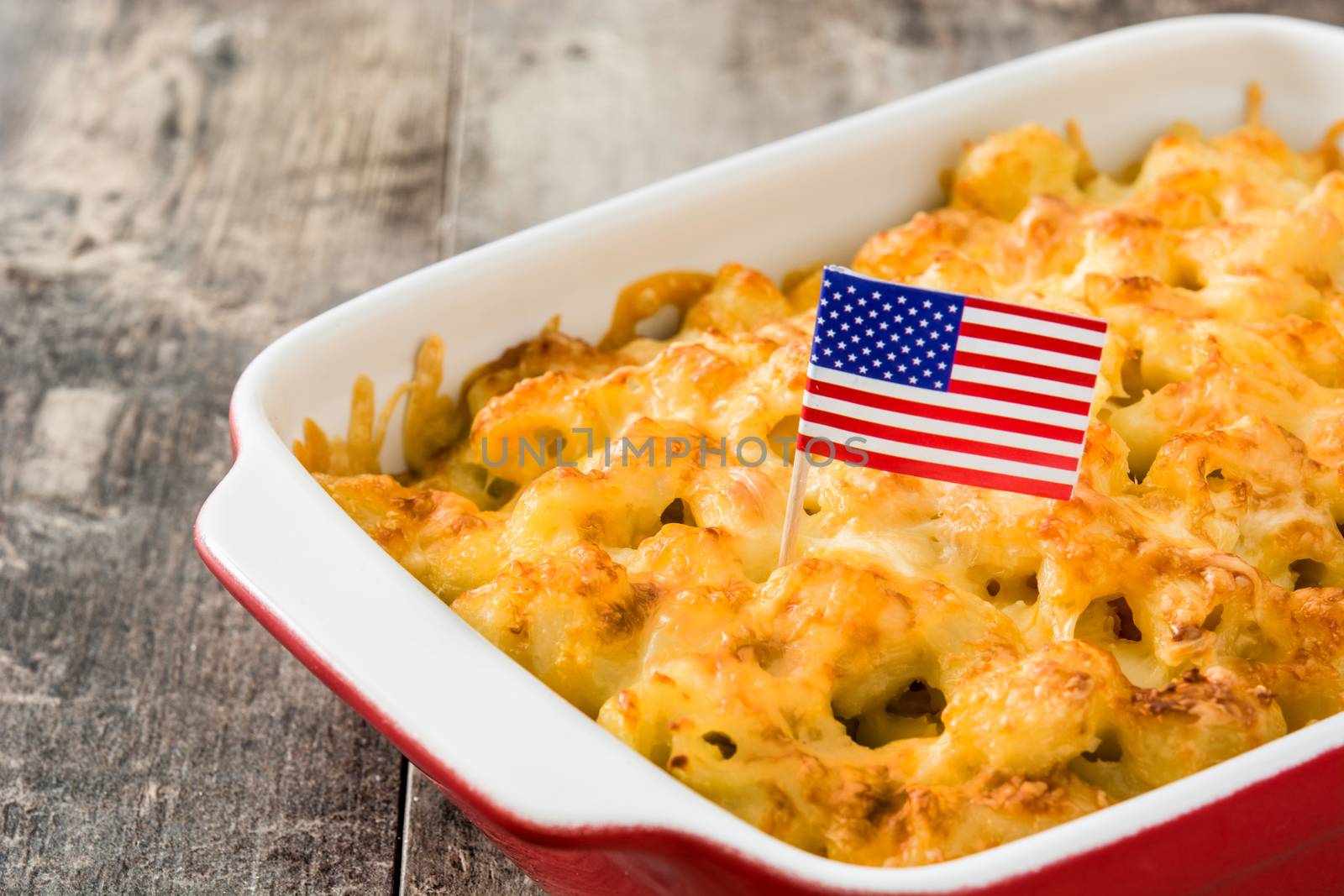 Typical American macaroni and cheese on wooden table