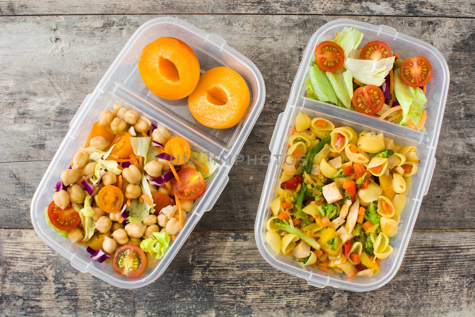 Lunch box with healthy food ready to eat on wooden table