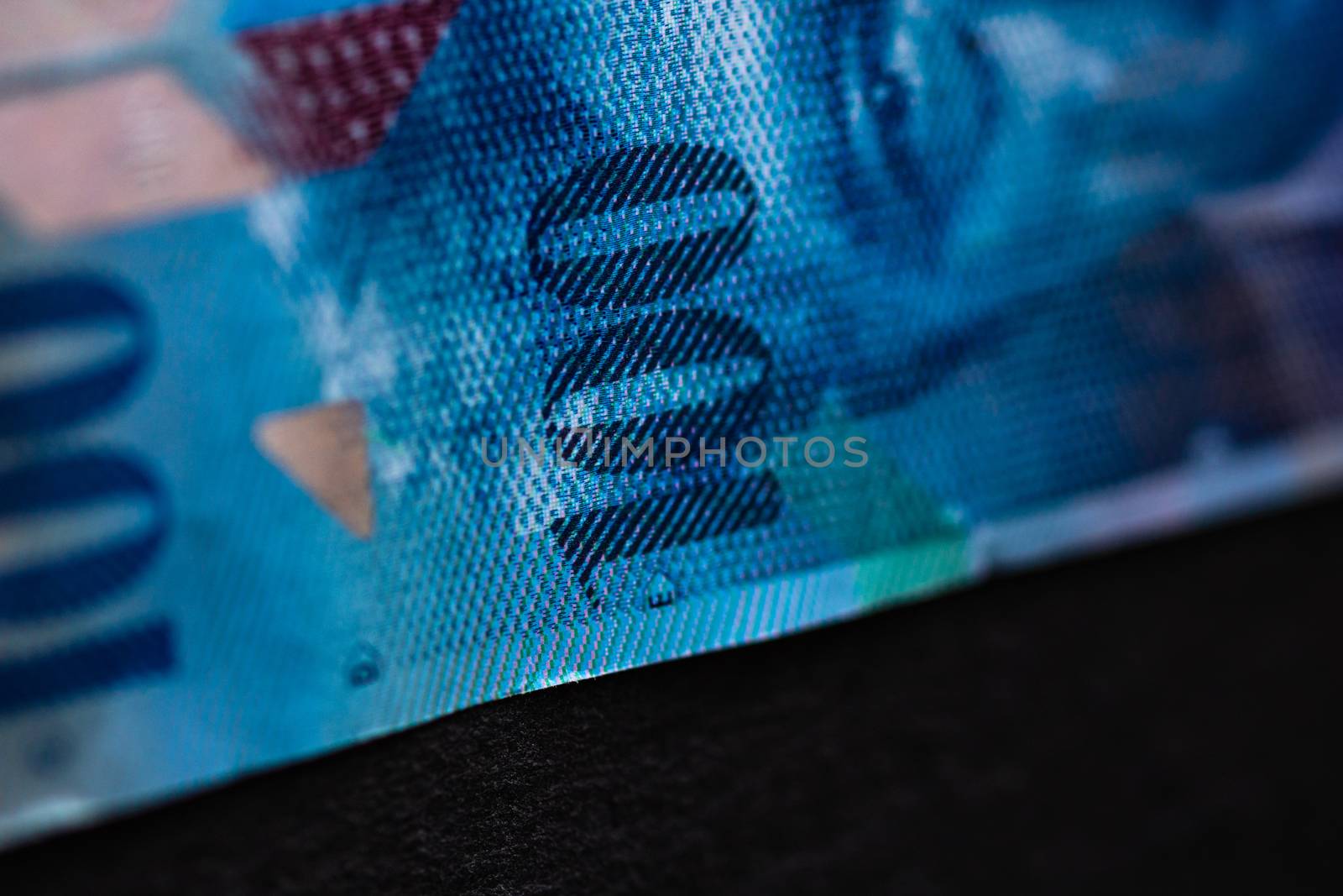 Selective focus on detail of 100 swiss franc banknote. Close up macro detail of money banknotes, swiss franc isolated. World money concept, inflation and economy concept