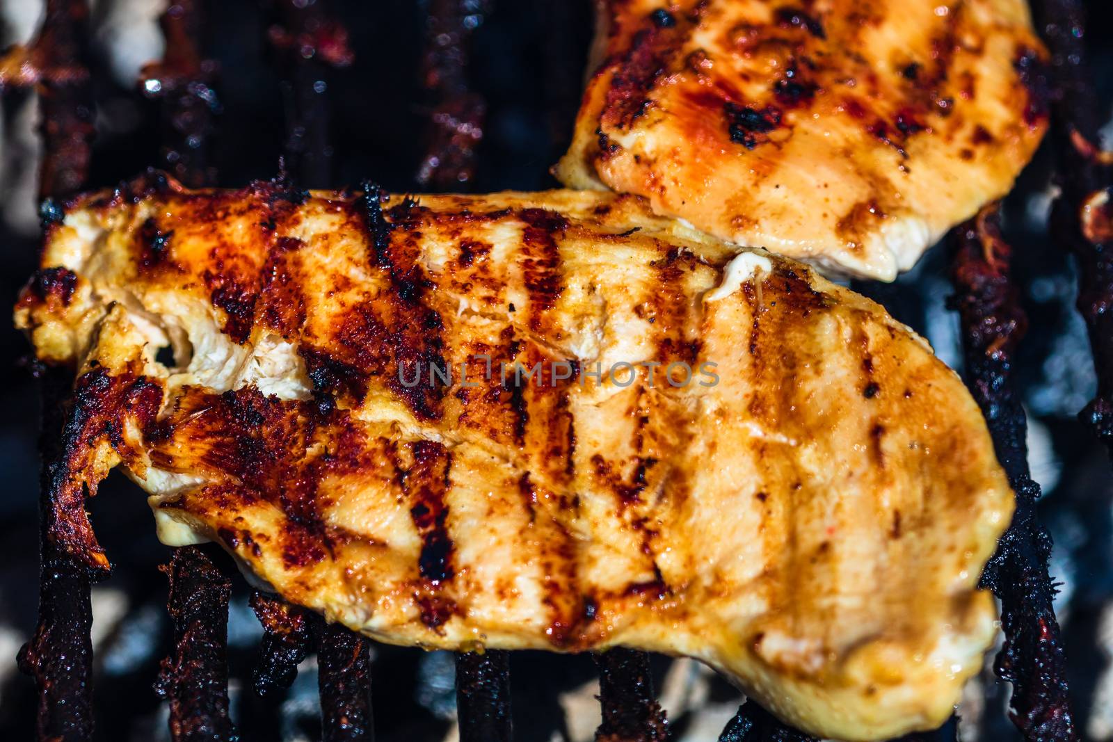 Chicken and pork steak grilled on a charcoal barbeque. Top view  by vladispas