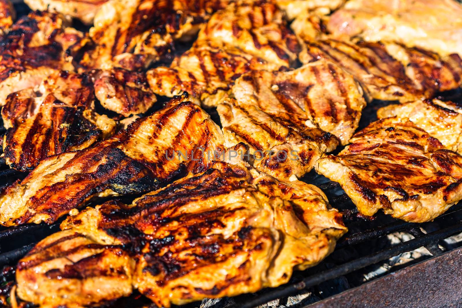 Chicken and pork steak grilled on a charcoal barbeque. Top view  by vladispas