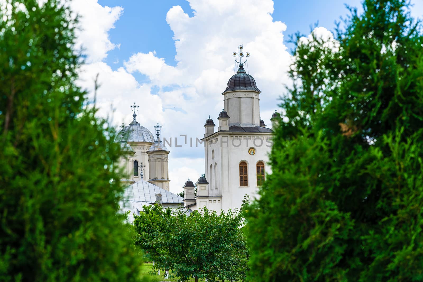 Pasarea monastery, orthodox church architectural details. View of Orthodox church and green churchyard.