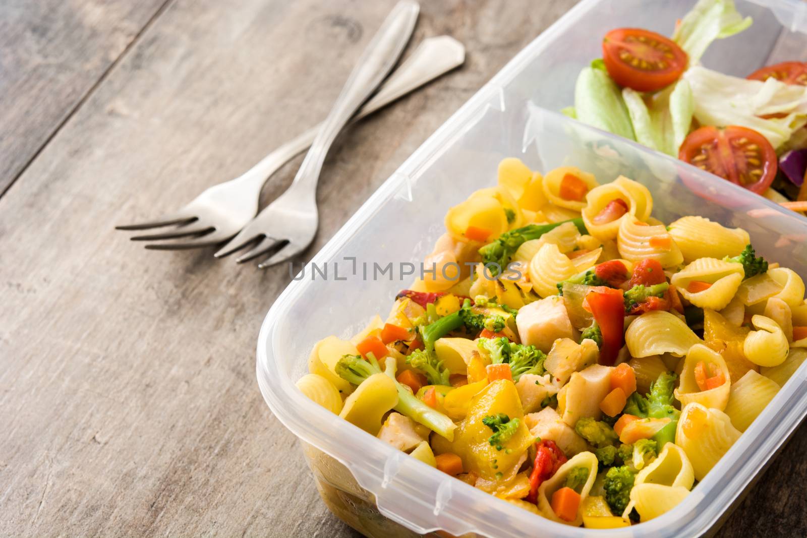 Lunch box with healthy food ready to eat Pasta salad on wooden table